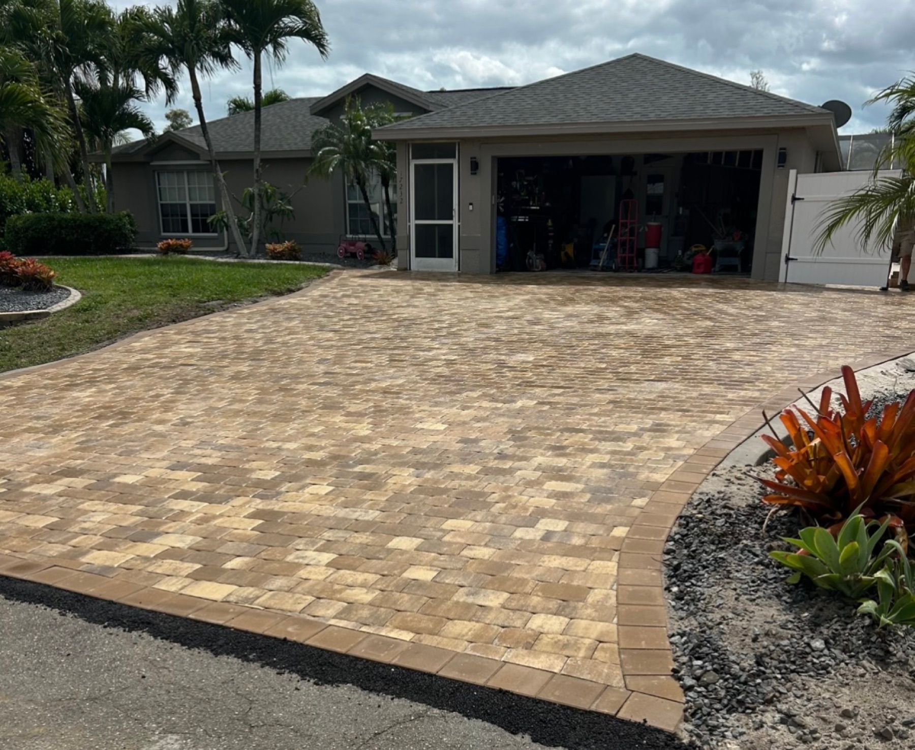 Residential paver driveway with a defined curved border edge